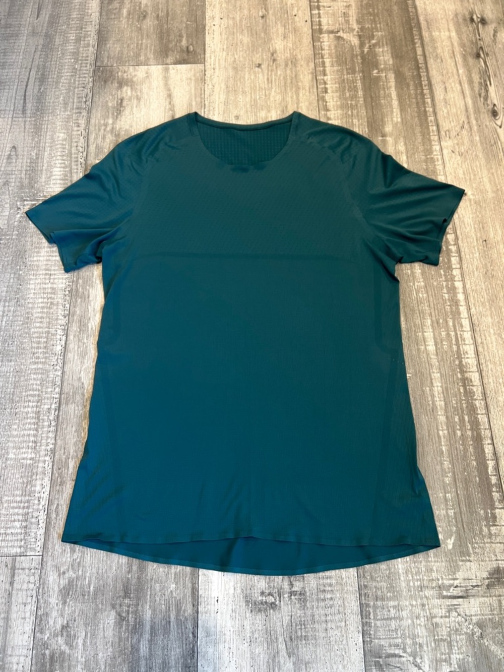 Teal Short Sleeve Athletic Shirt with mesh-like ventilation patterns